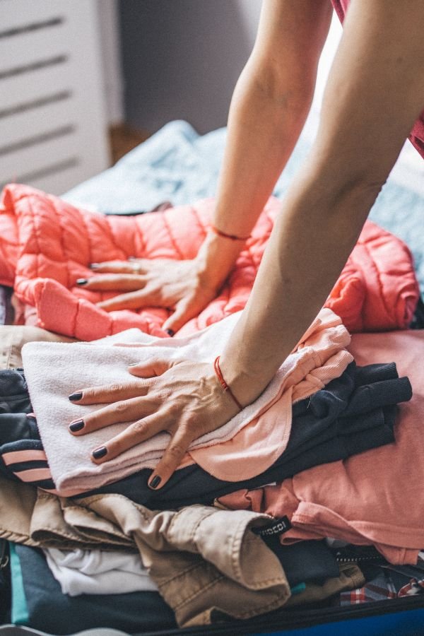 Woman packing her luggage for her next solo adventure.