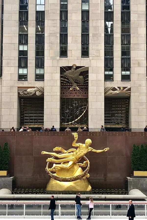 Rockefeller Center ice rink, and entrance. With Prometheus golden statue.