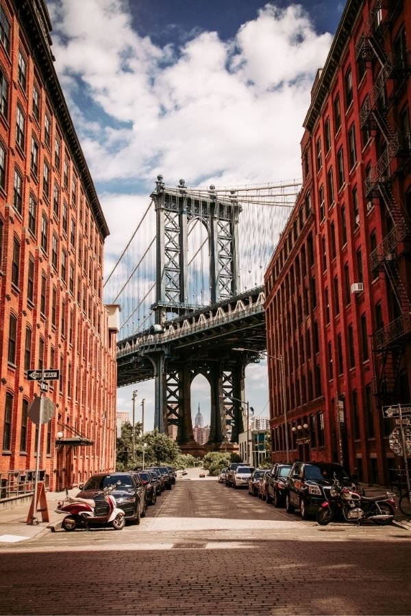 the Neighbourhood of DUMBO in Brooklyn, New York. With a view of the Manhattan Bridge in the background.