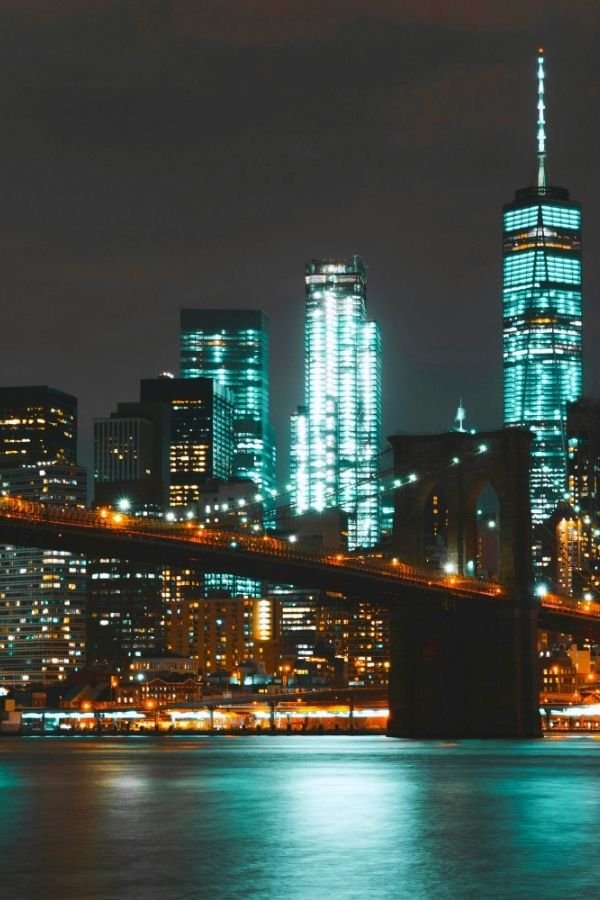 Manhattan Skyline, with the Brooklyn Bridge, at night. Photo taken from Brooklyn, New York.