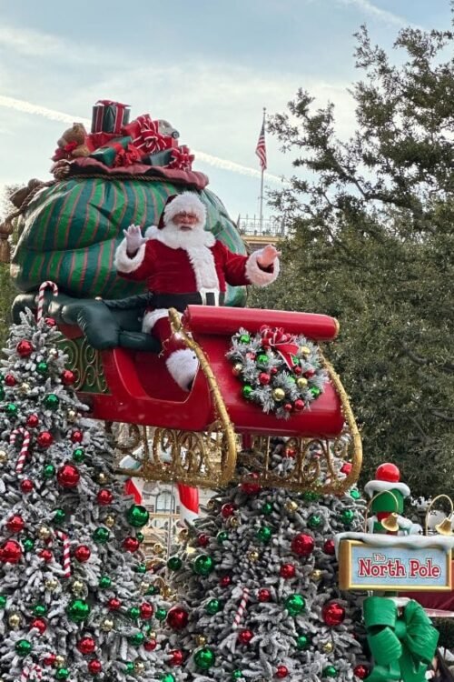 Hometown Christmas bucket list item - Santa Claus waving at the crowd and wishing everyone a Merry Christmas.