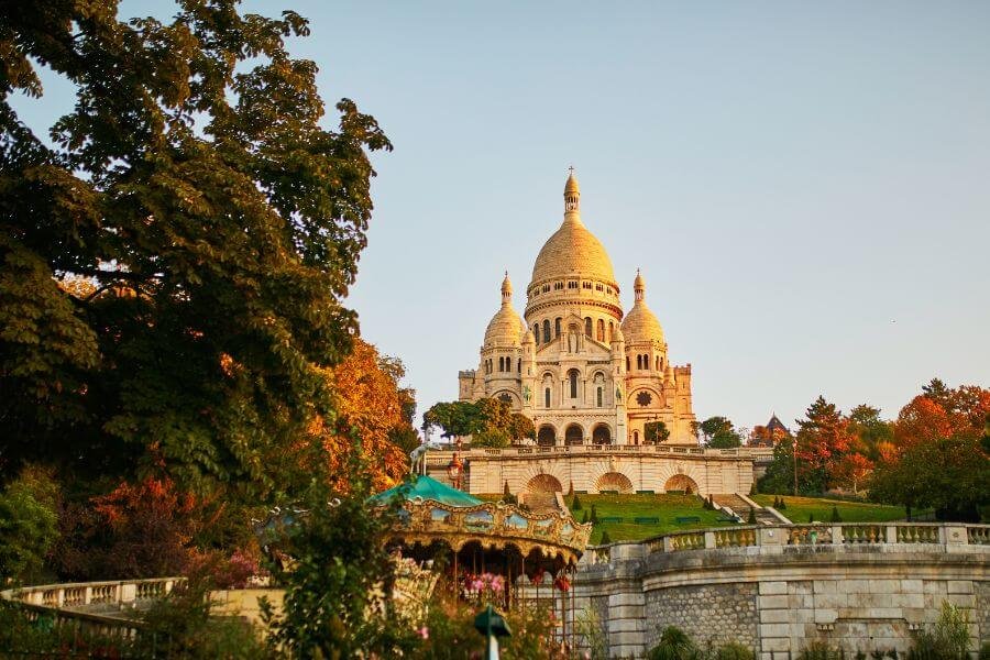 Basilica of Sacré-Cœur de Montmartre in Paris with marry-go round (carrousel)